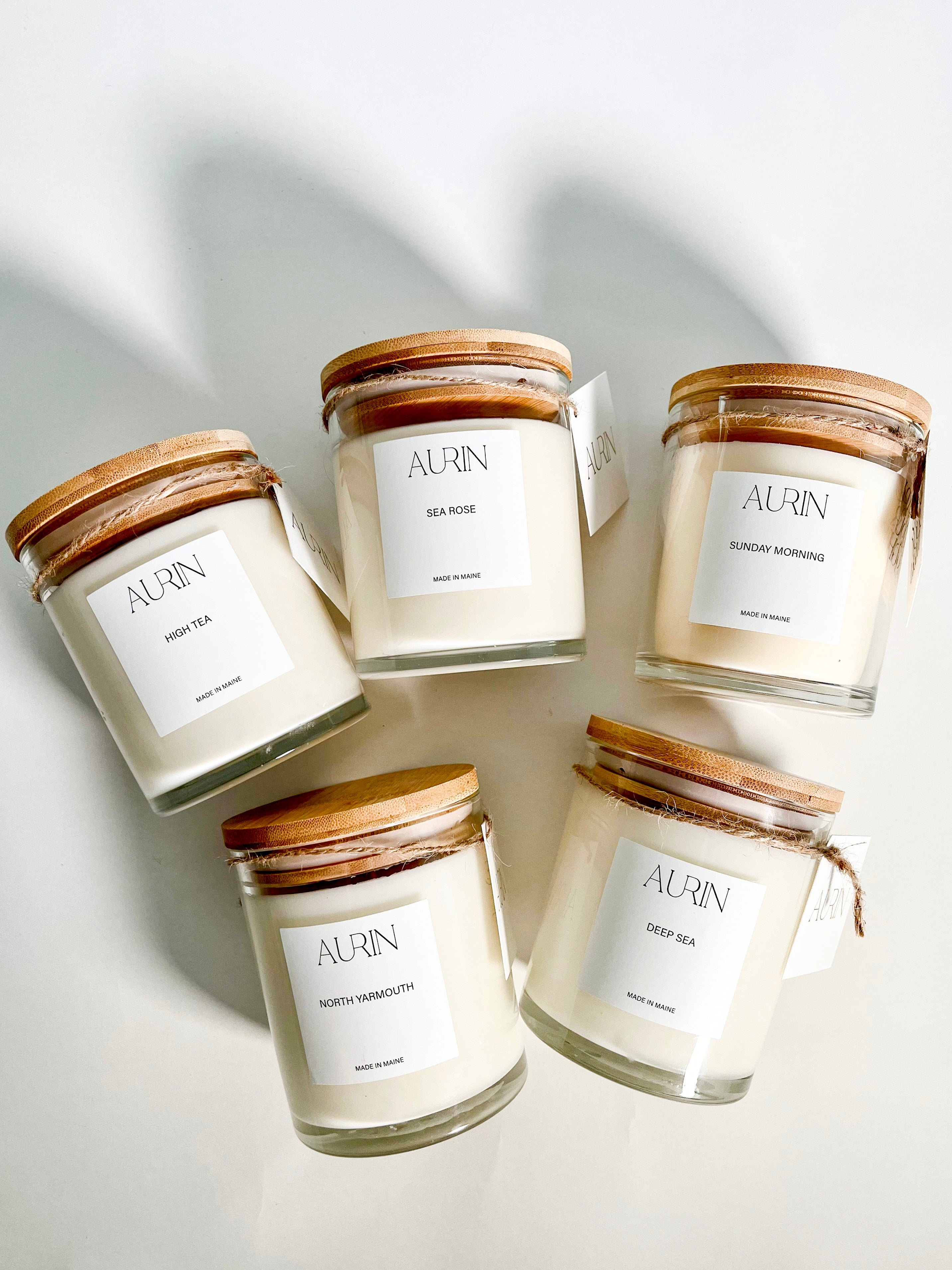 A selection of AURIN candles, made in Maineon a white background